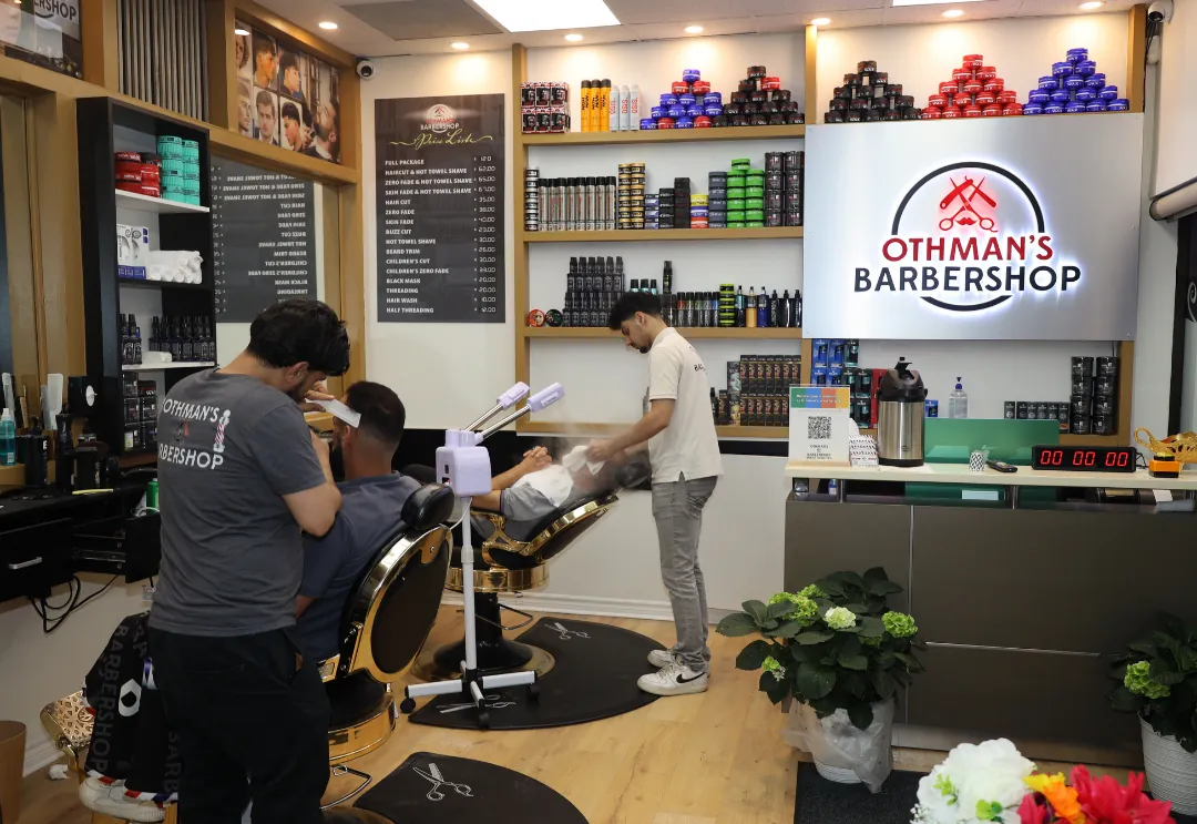Barbers at work inside Othman's Barbershop
